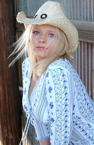 girl poses in a shed